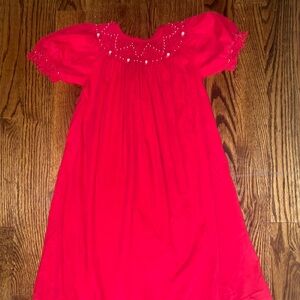 Girls red corduroy smocked dress with pearl accents and ruffle sleeves. Size 7